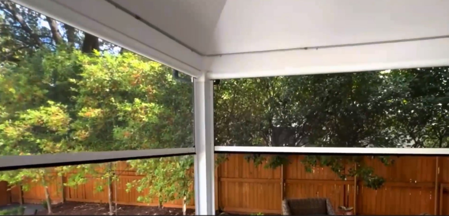 screen shades automatically rolling using motorization in backyard